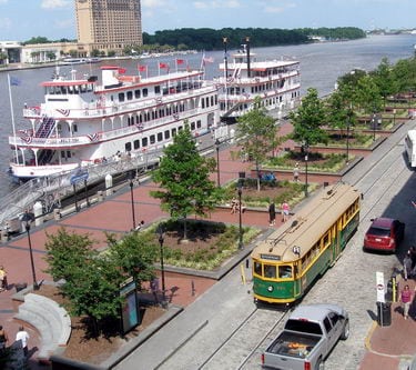 Savannah's Transportation System | Savannah Dream Vacations | Green Passenger Transportation Streetcar on River Street.